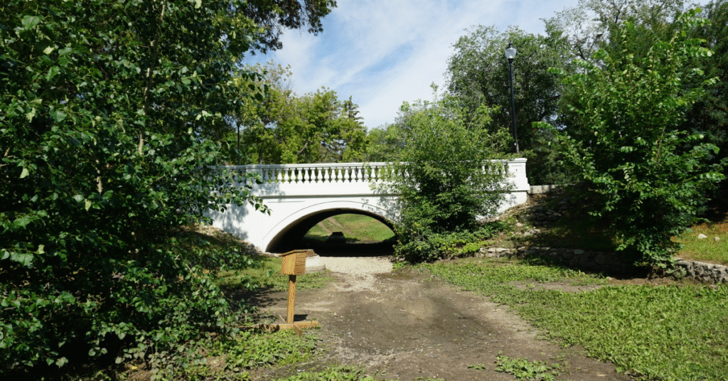 small white bridge over a dry stream bed