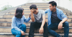 a man and a woman comforting another man