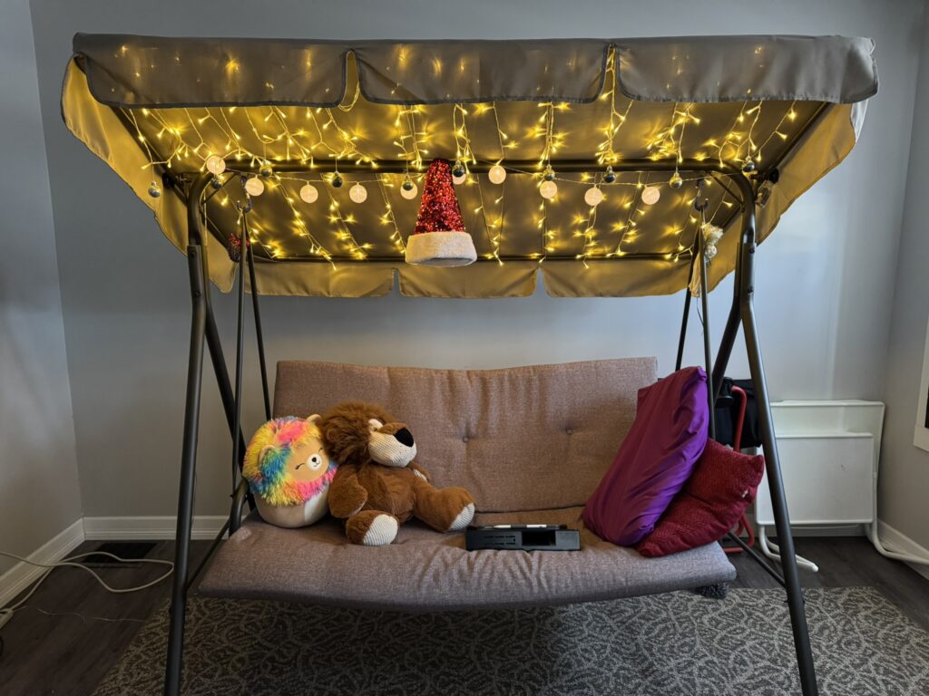 porch swing in living room with string lights