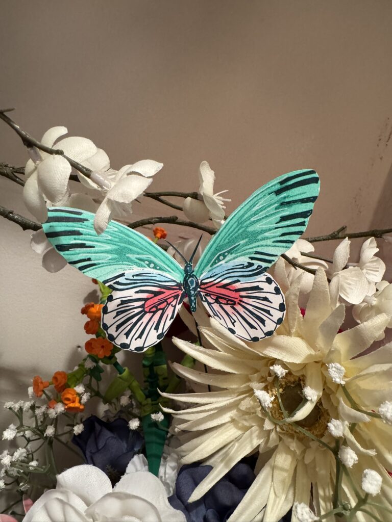 paper butterfly in faux flowers